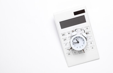 Fototapeta premium Calculator with an alarm clock on a white background. Time is money. Business concept