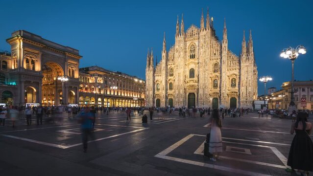 Timelapse view of people at the historic Piazza del Duomo at dusk in Milan, Italy.