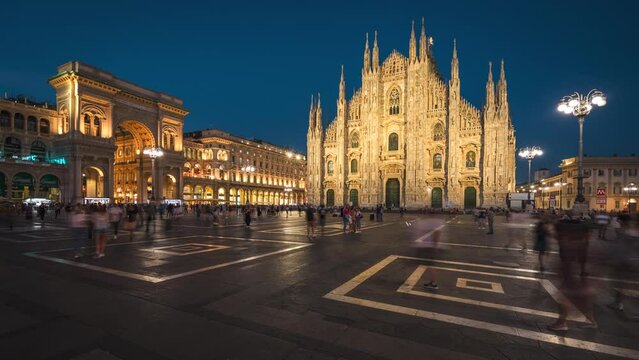 Timelapse view of people at the historic Piazza del Duomo square at dusk in Milan, Lombardy, Italy, zoom out. 