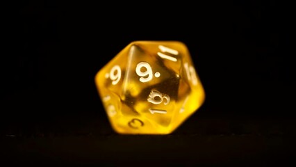 Yellow d20 tabletop board game die rotating tabletop gaming component amber color - Powered by Adobe