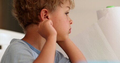 Contemplative toddler child thinking lost in thought. Imaginative pensive infant boy