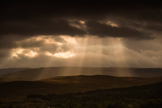 Sunbeams shining through dark storm clouds; Applecross peninsula wester ross scotland