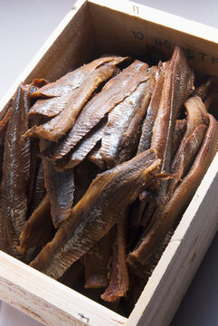 Smoked herring in a wooden crate