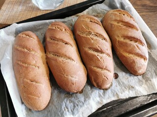 Homemade bread. Freshly baked baguettes on a baking sheet. Rye bread