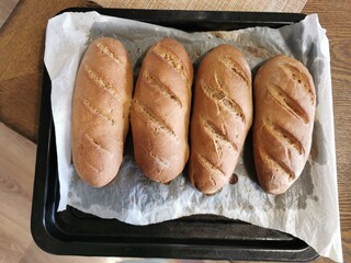 Homemade bread. Freshly baked baguettes on a baking sheet. Rye bread