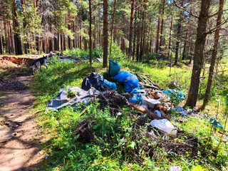 Pile of garbage on green grass in the nature environment problems. Nature protection. Environmental pollution