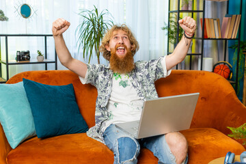 Surprised Caucasian man using laptop computer, receive mail good news message, shocked by sudden...