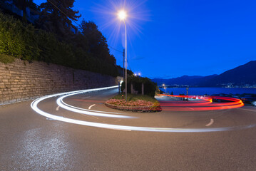 Light Trails Of Vehicle Headlights And Taillights On A Road; Locarno, Ticino, Switzerland