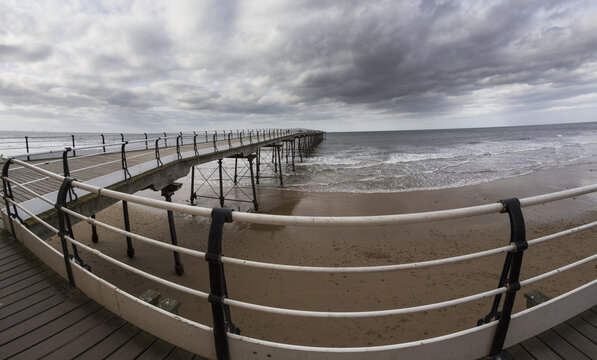A Walkway Leading Out To The Ocean; Saltburn, North Yorkshire, England
