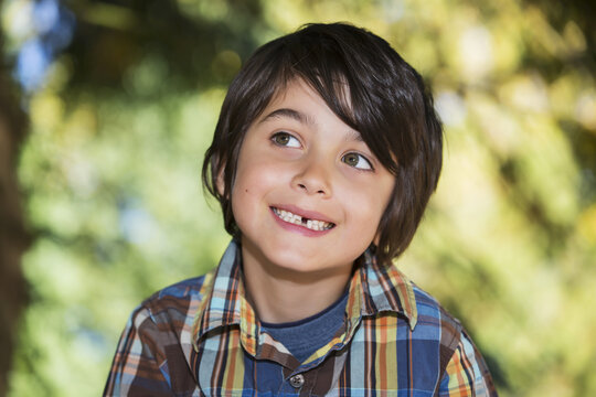 Portrait Of A Young Boy With A Missing Tooth; Langley, British Columbia, Canada