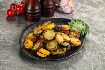 Roasted young zucchini in the plate