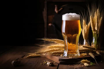  A glass of beer on a background of hops and grains on a dark background. © Maksymiv Iurii