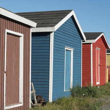 Sheds In Various Colours In A Row; Trout River, Newfoundland, Canada