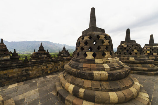 Latticed Stone Stupas Containing Buddha Statues On The Upper Terrace, Borobudur Temple Compounds, Central Java, Indonesia