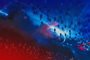 Nightclub atmosphere, ceiling, interior with neon, red and blue light in smoke with disco shiny ball