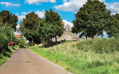 Beautiful Limburg countryside landscape, empty road to rural village and medieval church - Venlo (Hout Blerick), Netherlands