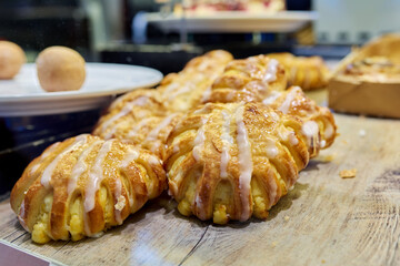 Close-up of bakery pastry shop display with fresh sweet buns with cream