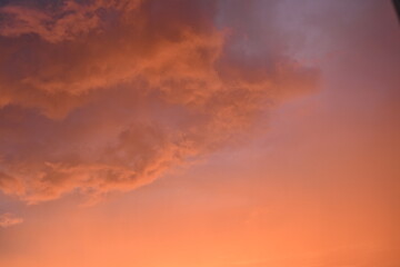 pink blue rainy clouds against the background of the winter sky illuminated by the rays of the sun,...