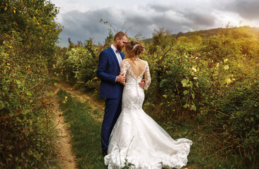 Wedding ceremony of the groom and beautiful bride in nature, happy holiday of the newlyweds. A woman and a man are getting married.