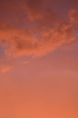 Obraz premium evening sunset, rays of the sun through cirrus pink clouds against the background of the sunset sky, 