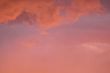 pink blue rainy clouds against the background of the winter sky illuminated by the rays of the sun,...