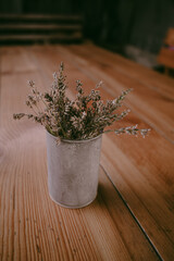 Dry lavender bouquet in a modest vase on a wooden table. Wild flowers in a vase. The scent of lavender. Rural scene. Plant decor. Violet flowers. Dry flowers.
