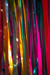 incense sticks in a temple,multi-colored background and colored rag stripes