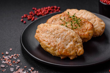 Delicious juicy cutlets or meatballs from minced chicken with salt and spices