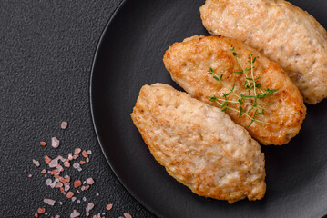 Delicious juicy cutlets or meatballs from minced chicken with salt and spices