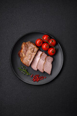 Fototapeta na wymiar Delicious juicy pork or beef steak cooked on the grill with salt and spices