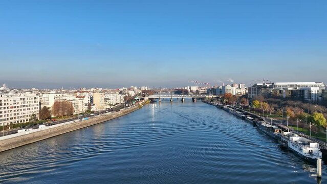 Above Seine River: Paris, &Icirc;le de la Jatte, La D&eacute;fense, barge under clear skies.
