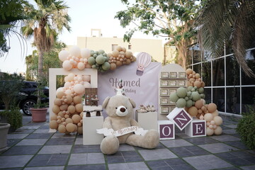 Birthday decorations, teddy bear theme birthday boy. Baby one years old. Baby decoration with teddy bears balloons, candies and banner.  - obrazy, fototapety, plakaty