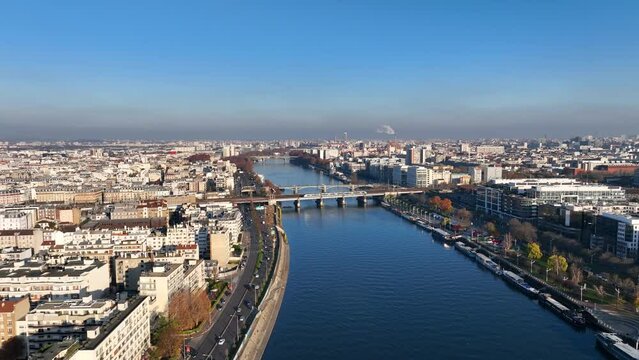 Aerial charm: Paris, Seine, &Icirc;le de la Jatte, La D&eacute;fense, and a sunny barge crossing.
