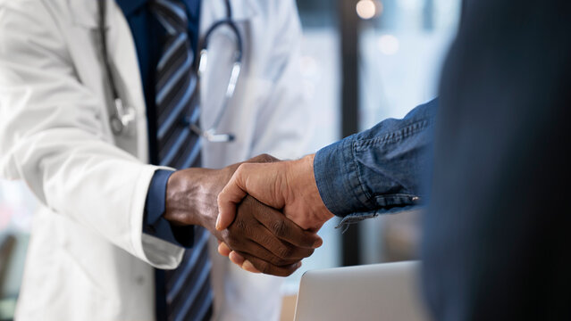 Doctor shakes hands with a patientd patient are at clinic