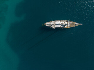 Drone topdown shot of a yacht, sailing boat