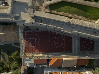 Drone topdown shot of a basketball court in old town