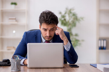 Young male employee working in the office