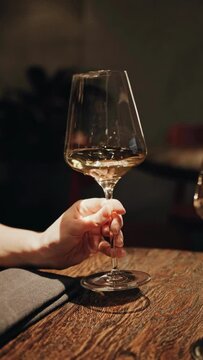 hand shaking glass of white wine. instagram reels format