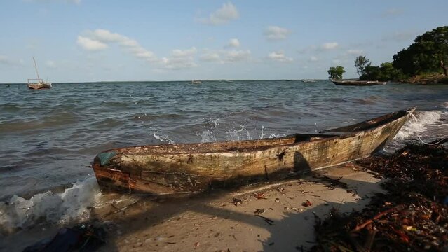 orbiting destroyed and broken wooden boat on Africa coast