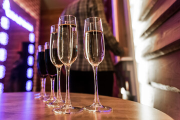 Chilled champagne or white sparkling wine, alcohol in a glass, red wine on table a blurred...