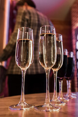 Chilled champagne or white sparkling wine, alcohol in a glass, red wine on table a blurred background of the interior