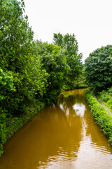 Shady part of the Orange coloured canal from clay in tunnel, The Trent and Mersey Canal.