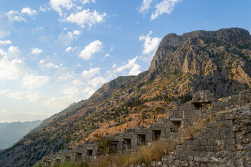 Fototapeta na wymiar A view of a castle wall on a rocky mountain at Kotor Bay in Montenegro