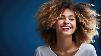 Happy active African American woman on blue background.