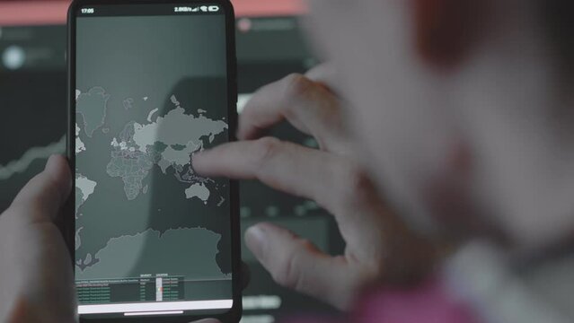 Cyber attack, Cyber security and global network concept. World map on mobile phone showing cyber attack in Asia, China.