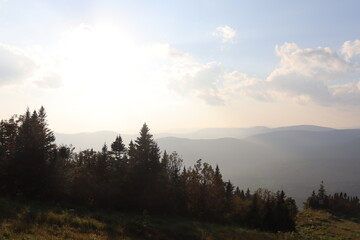 Autumn landscape with a beautiful cloudy sky, trees and mountains. Autumn background and the nature in Canada. Outdoors activities and hiking trail in the forest and in national park. 