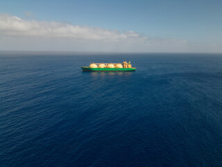 tanker ship with liquid natural gas transporting fuel in open sea waters, aerial