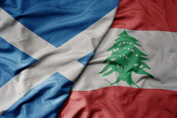 big waving national colorful flag of scotland and national flag of lebanon .