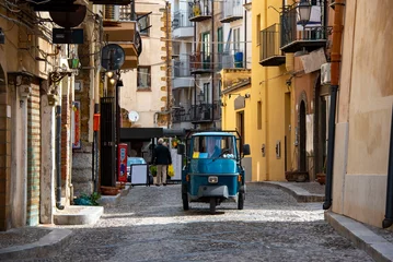 Tuinposter Cobblestone Street in Cefalu - Italy © Adwo