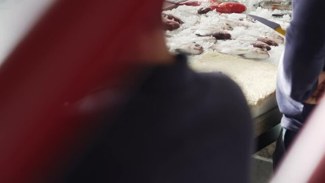 Footage of busy fish stals at Farmers Market in Funchal city